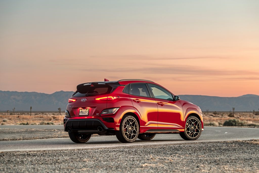 The rear end of a red Kona N at sunset