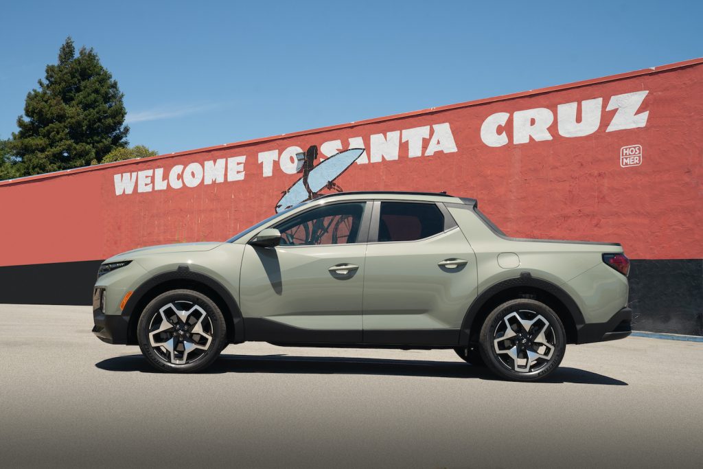 This is a publicity photo of a sand colored 2022 Hyundai Santa Cruz parked in Santa Cruz, California. This is one of the true compact trucks coming to the market.