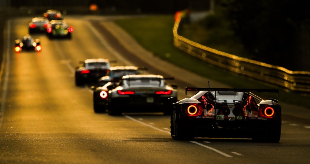 Sports cars driving down the Mulsanne Straight at Le Mans Circuit de la Sarthe