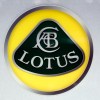 A yellow, black, and silver Lotus logo on display at the 2018 Paris Motor Show
