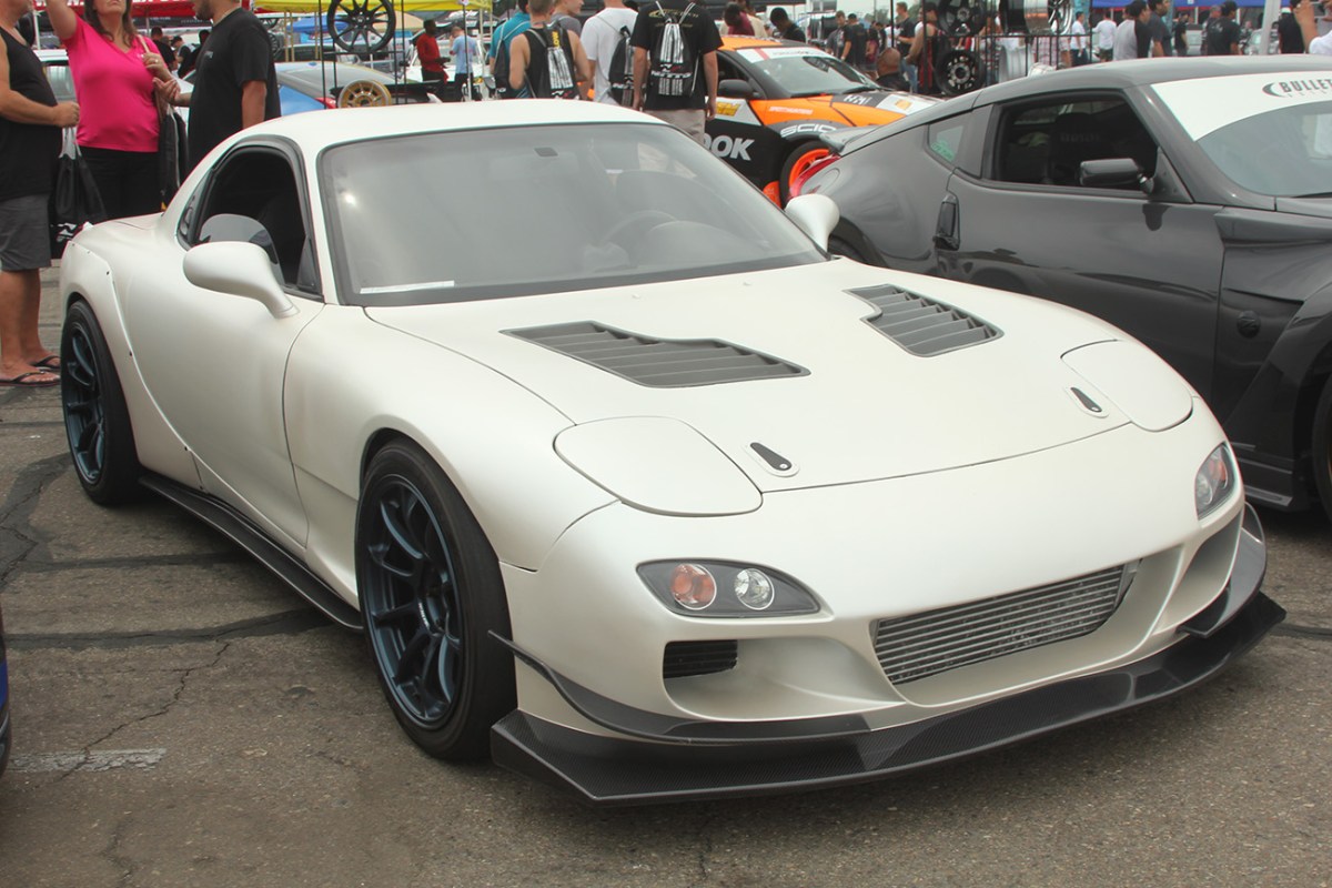 White 1995 Mazda RX-7 with a body kit.