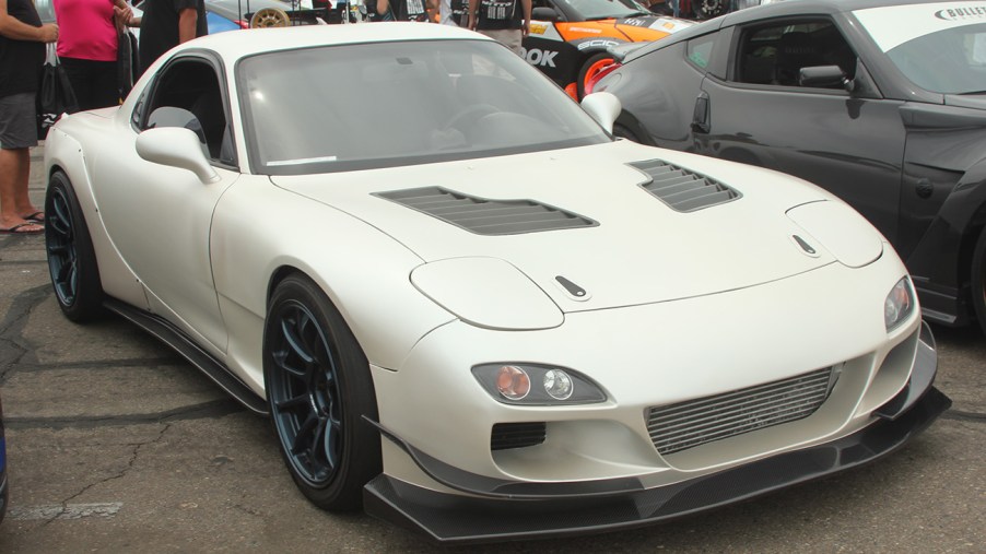 White 1995 Mazda RX-7 with a body kit.