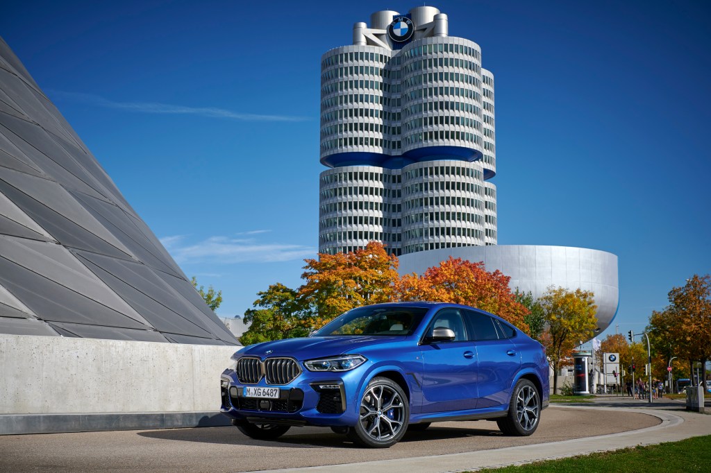 The BMW X5 M50i in blue outside the brand's factory