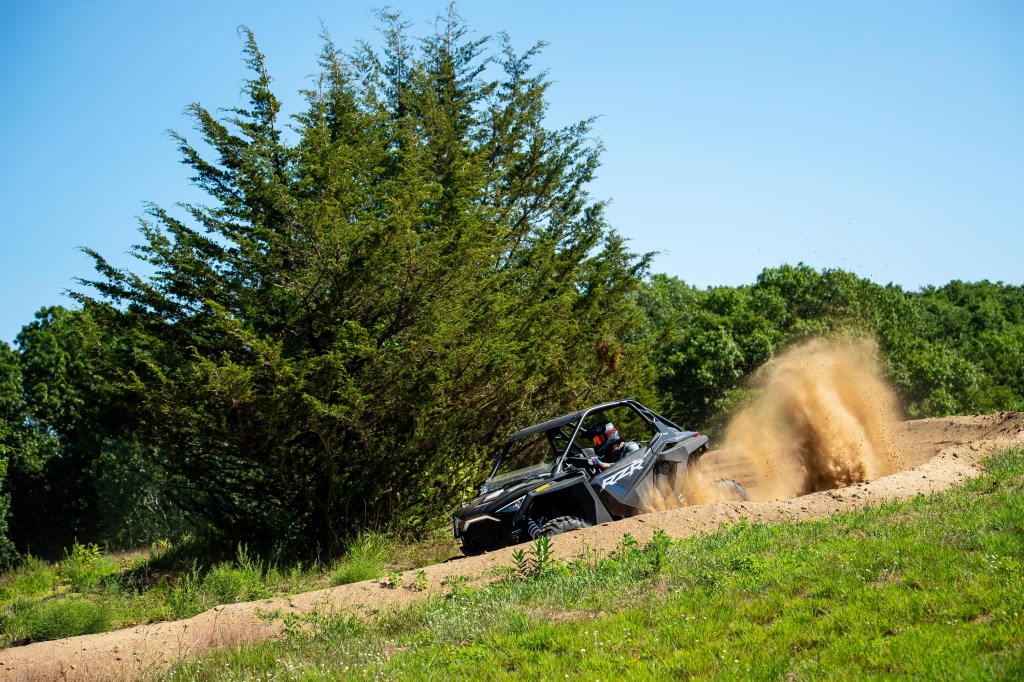 Polaris RZR going through a dirt burm