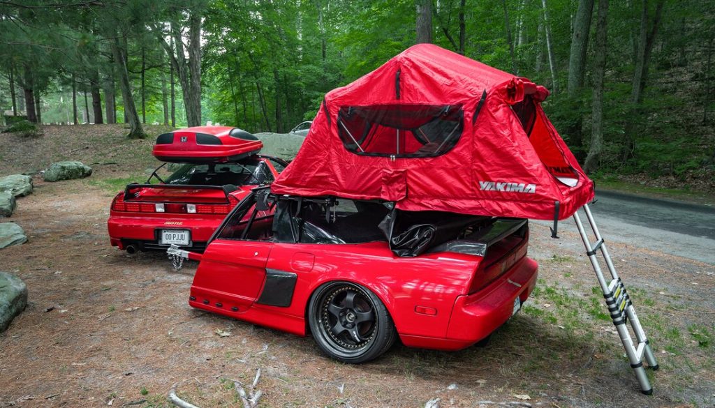 A red Acura NSX with a roof tent and matching trailer, made from another NSX