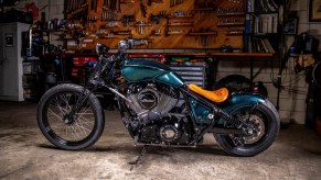 The side view of Paul Cox's and Keino Sasaki's metallic-green custom 2022 Indian Chief in a garage