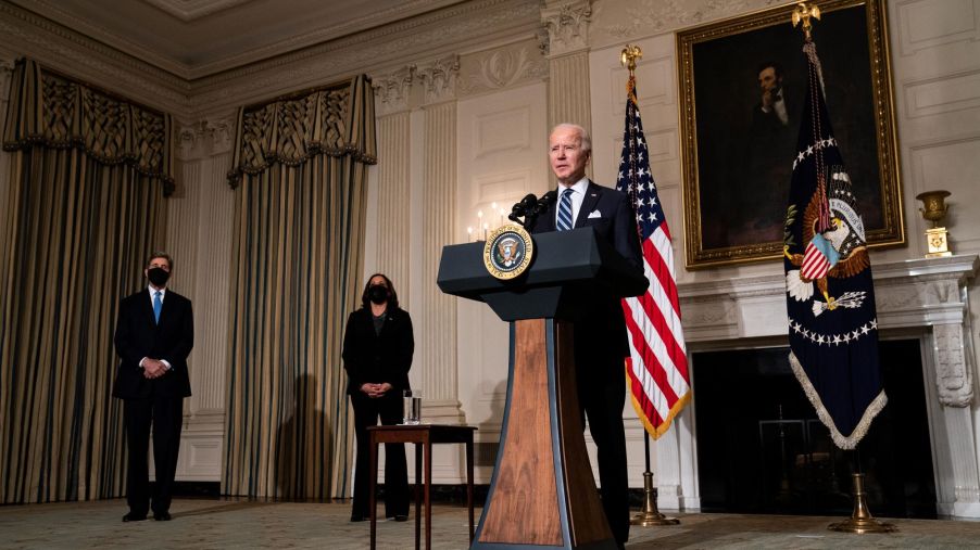President Joe Biden speaking about climate change at the White House as John Kerry and Kamala Harris stand at his side