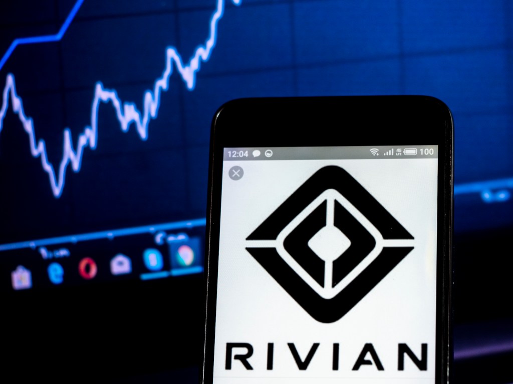 The Rivian logo is displayed on a smartphone with a blue line graph in the background