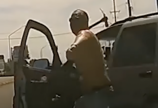 Man Throwing Pickaxe At Windshield