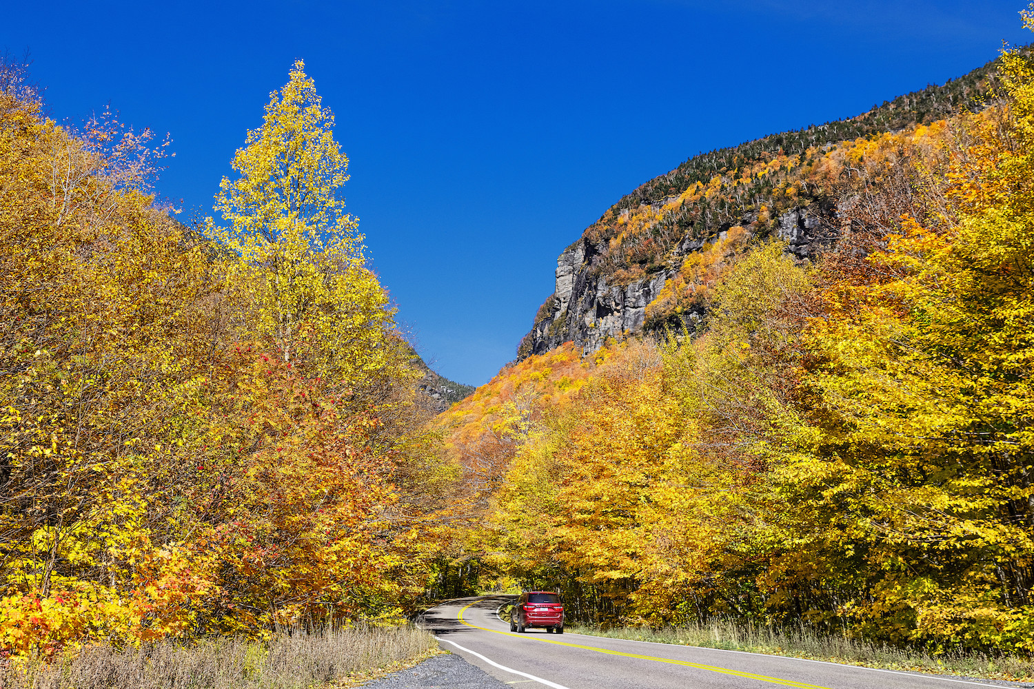 Scenic autumn drive through Smugglers Notch, one of the best scenic drives for leaf-peeping in the northeast