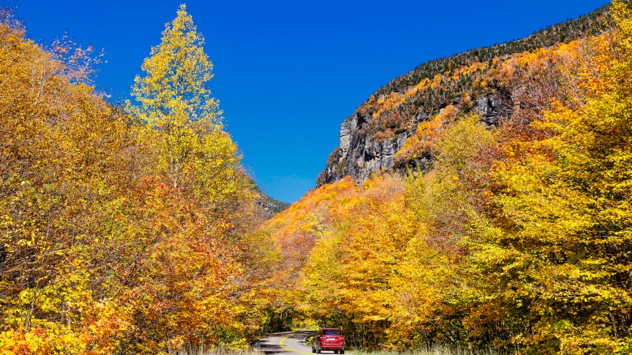 Scenic autumn drive through Smugglers Notch, one of the best scenic drives for leaf-peeping in the northeast