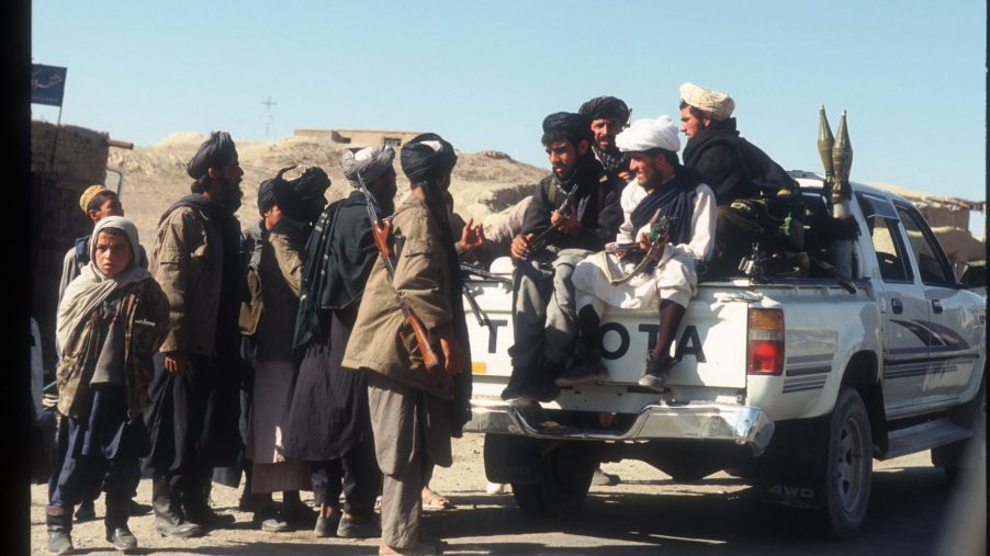 Taliban loaded into the back of an old Toyota pickup truck