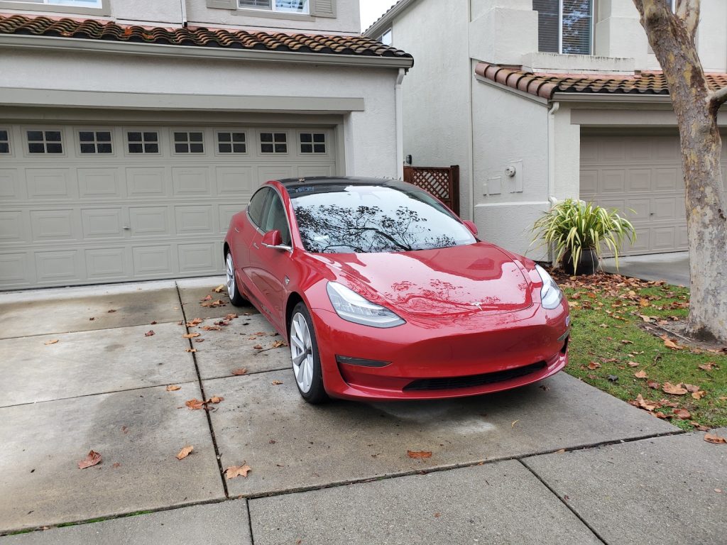 A red Tesla Model 3 In Driveway, the Tesla Model 3 is one of the best used electric cars