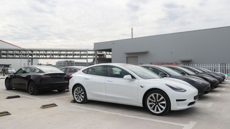 Tesla Model 3 vehicles parked outside of a Tesla factory in Shanghai, China