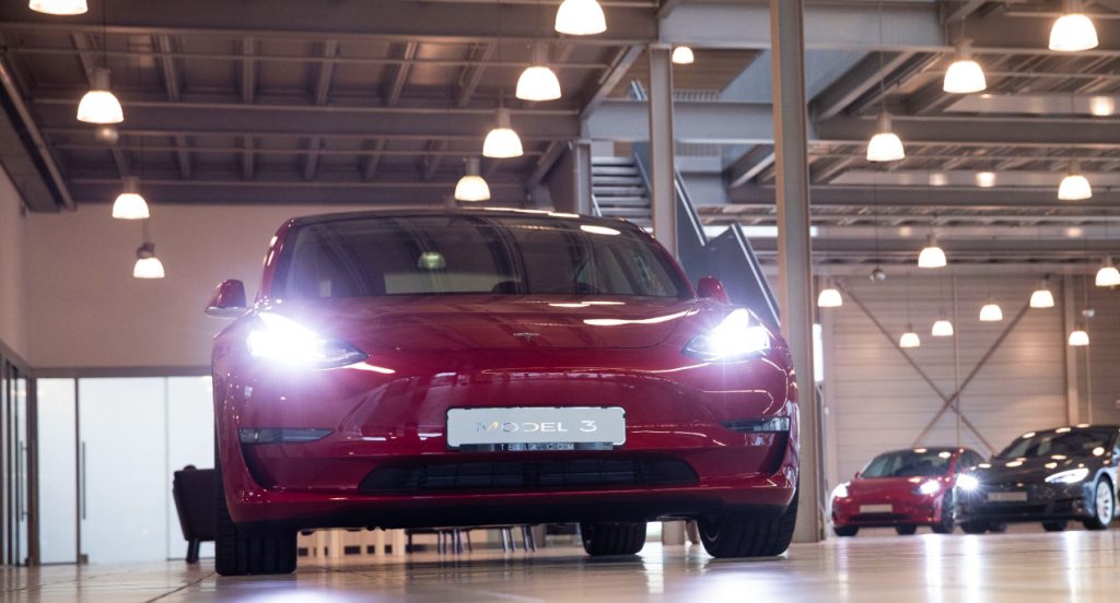 A red Tesla Model 3.