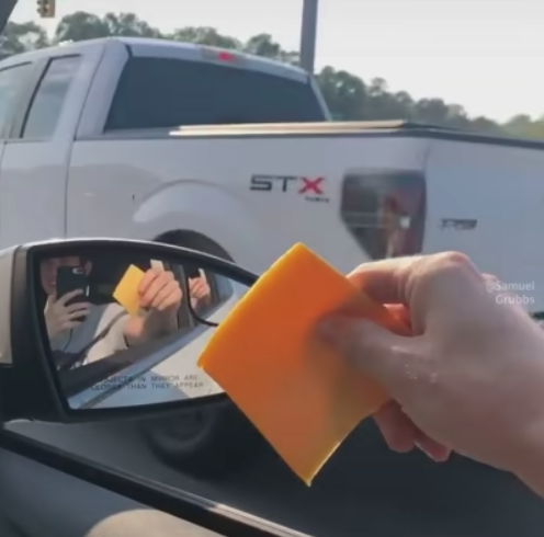 Throwing cheese slices at cars 