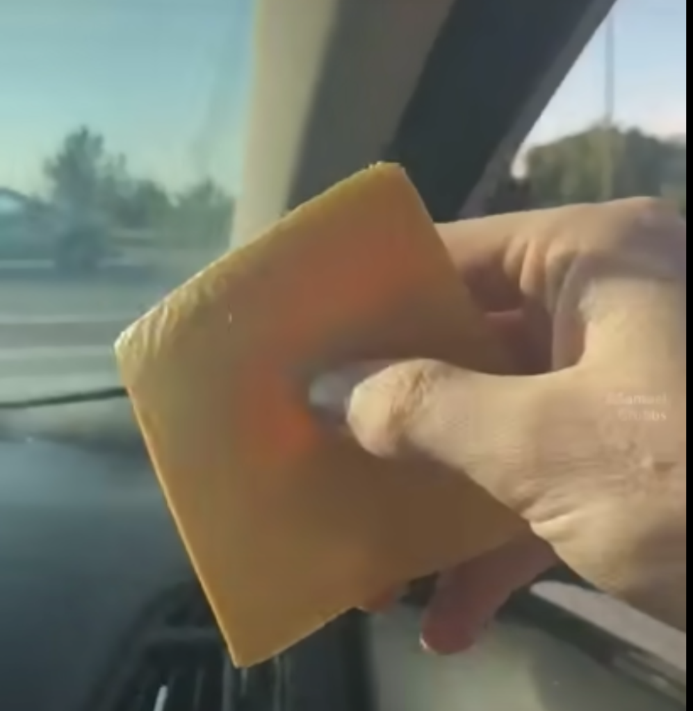 A cheese slice about to be thrown onto passing car
