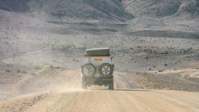 A Toyota Land Cruiser driving in the desert in Fish River Canyon