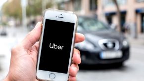The Uber ride-share app open on a smartphone as the driver and ride arrive to pick up a passenger