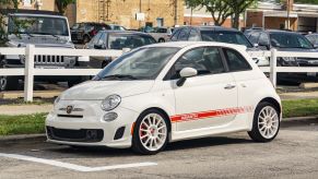 The author's white-and-red 2013 Fiat 500 Abarth on a city street