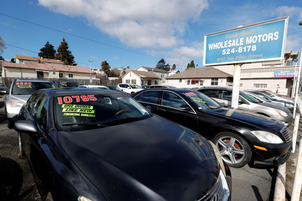 Used cars with prices on their windshields in a California lot