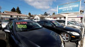 Used cars with prices on their windshields in a California lot