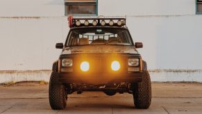 Jeep Cherokee front grill with added lights on a 90s overlander