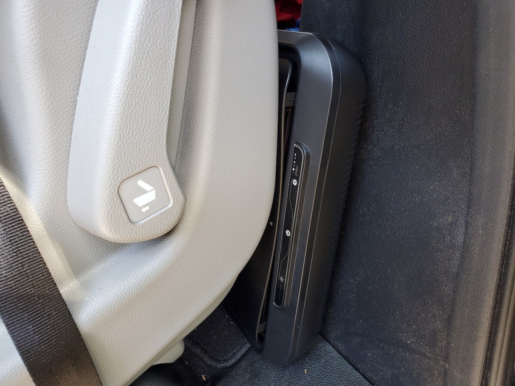 Close-up of Medify Air MA-CAR HEPA air purifier behind seat in a vehicle
