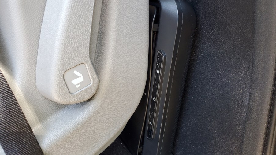 Close-up of Medify Air MA-CAR HEPA air purifier behind seat in a vehicle