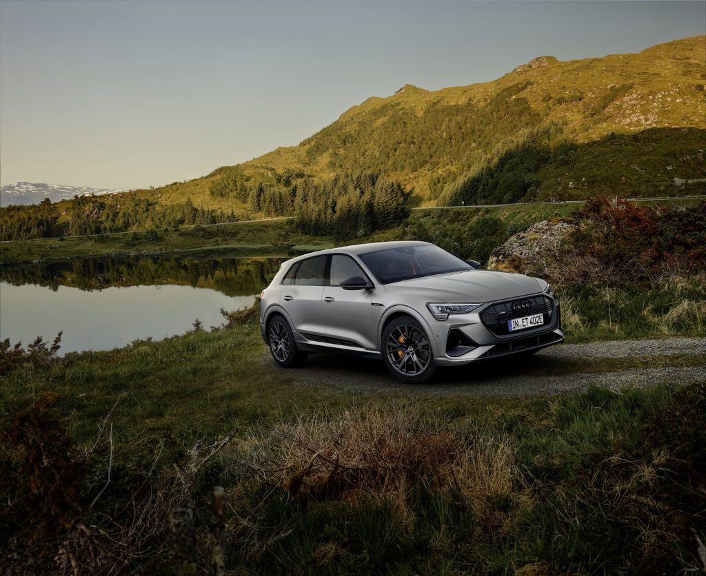 an audi q4 e-tron parked by a lake
