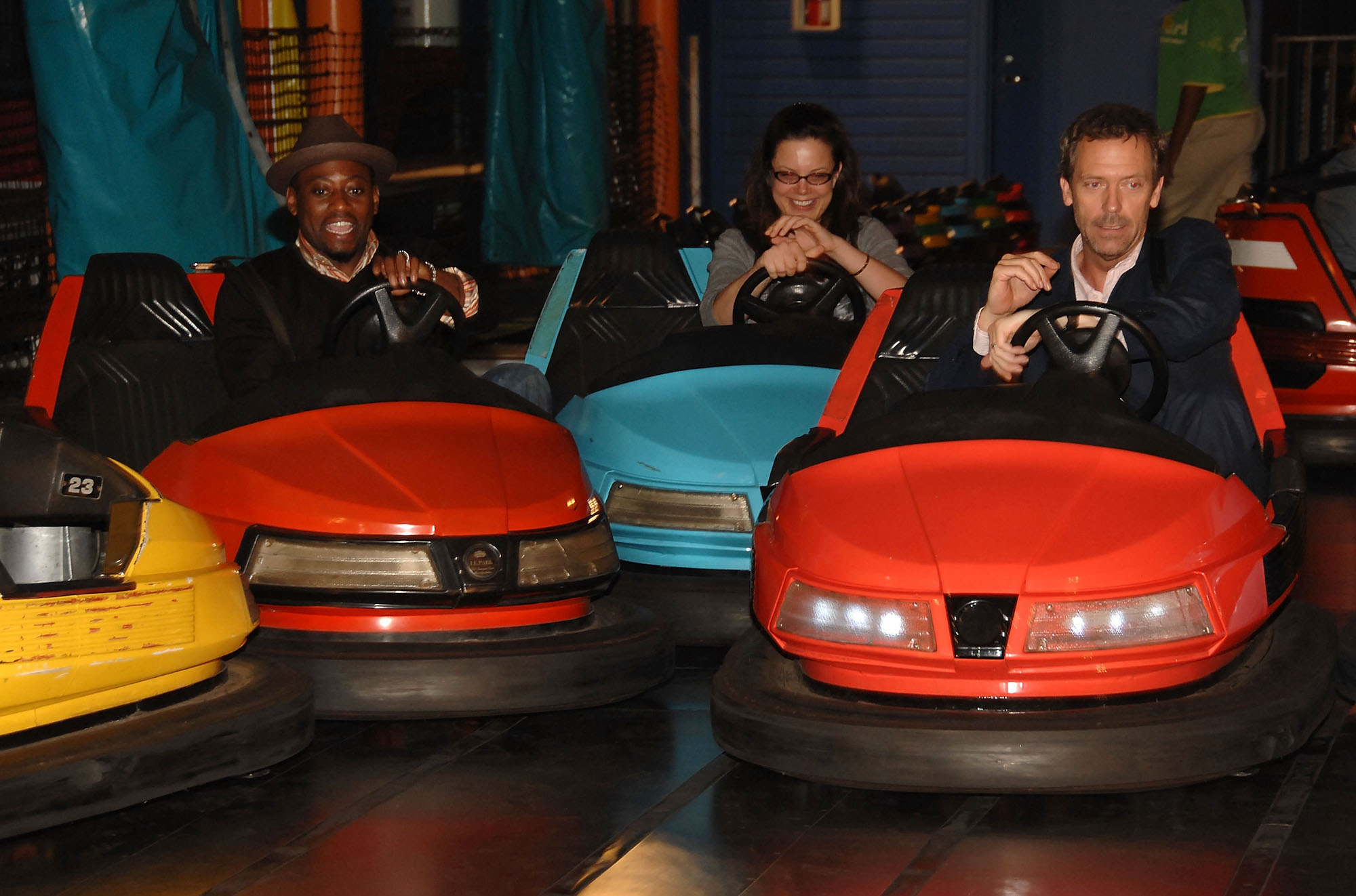 Actors Omar Epps and Hugh Laurie ride bumper cars in Pacific Park on the Santa Monica Pier in California in July 2007