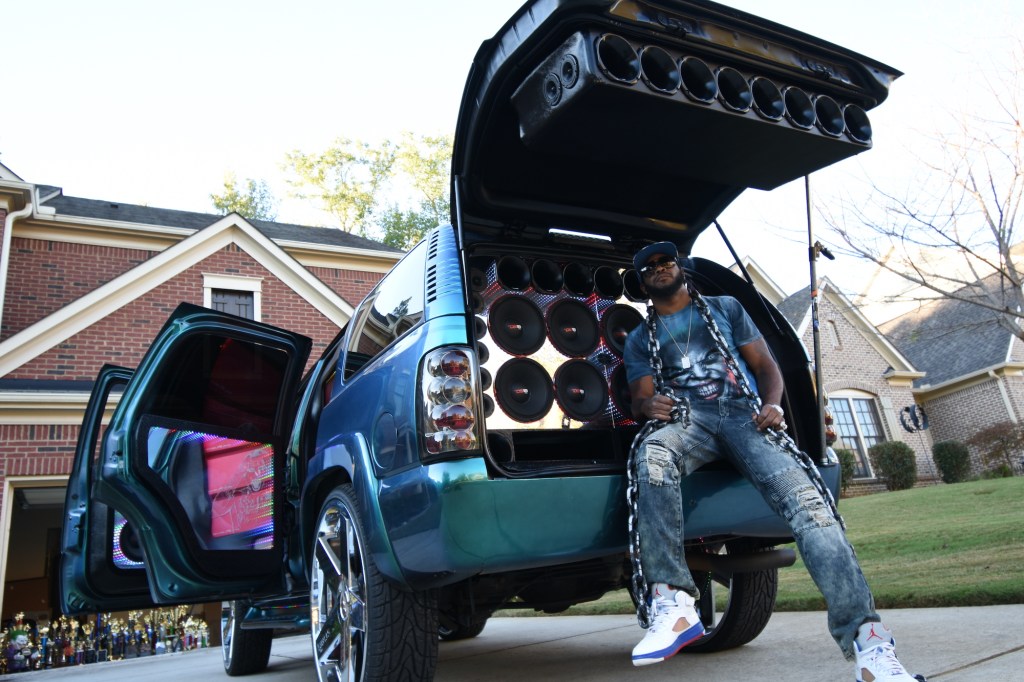 Jay Jones, known as 'Joka' sits in the speaker-filled boot of his customized 2004 Tahoe truck.