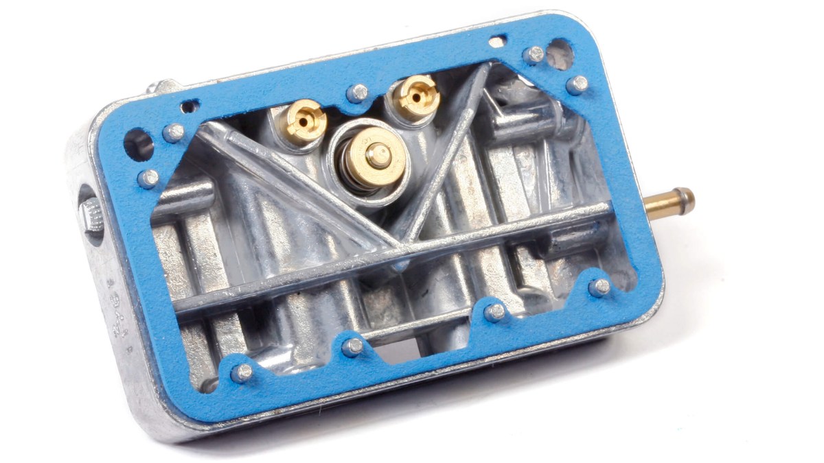 A carburetor metering plate with a blue gasket.