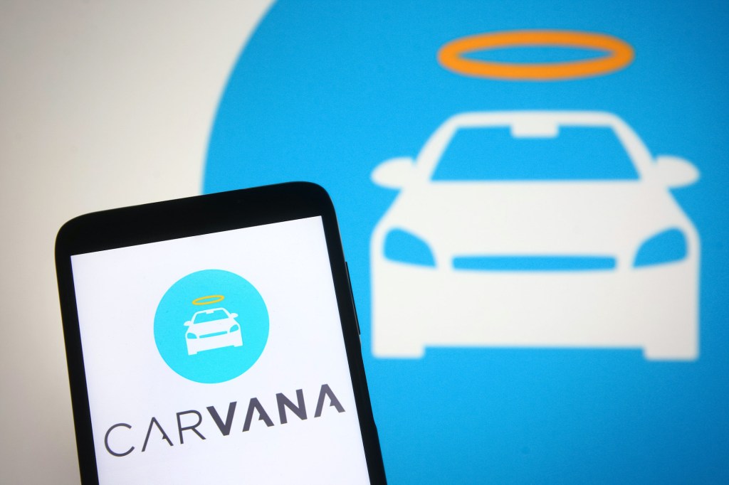 Carvana logo is seen on a smartphone screen. 