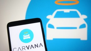 Carvana logo is seen on a smartphone screen.