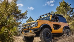 The 2022 Ford Bronco in Cyber Orange shown on a trail