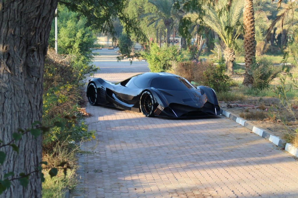 a Devel sixteen parked on a walk way in a garden and wil have the most horsepower of any car