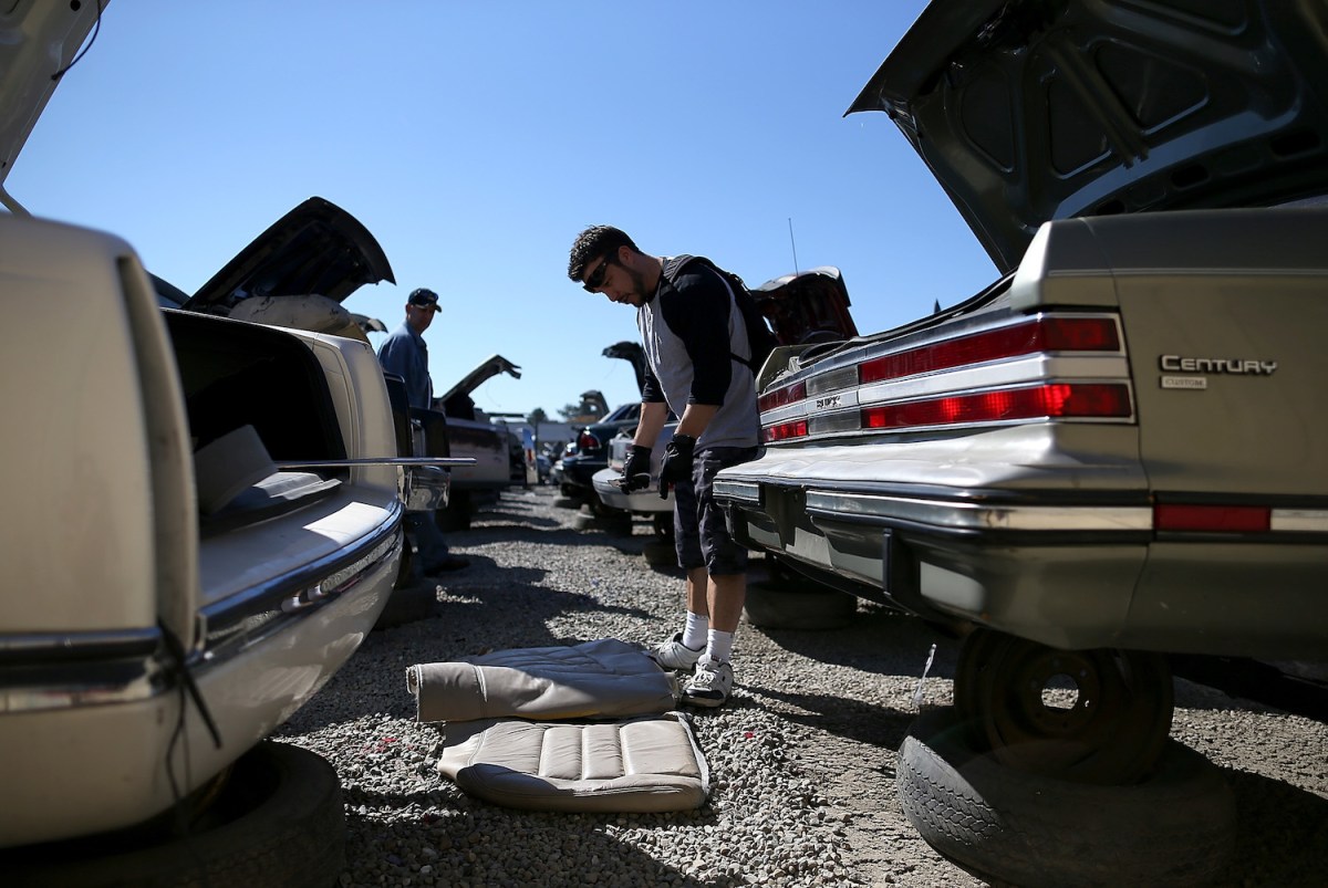 Dismantling cars at a salvage yard in Oakland, CA