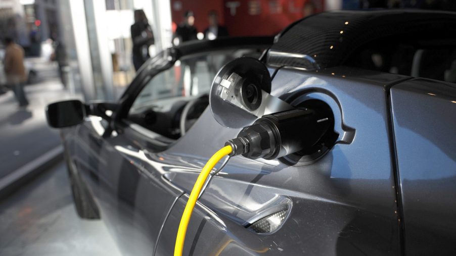An electric cable is plugged into a Tesla Roadster Sport