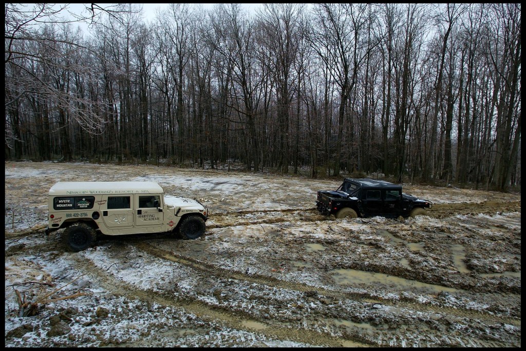 A beige H1 hummer winches a black H1, it is capable of winning a tug-of-war battle