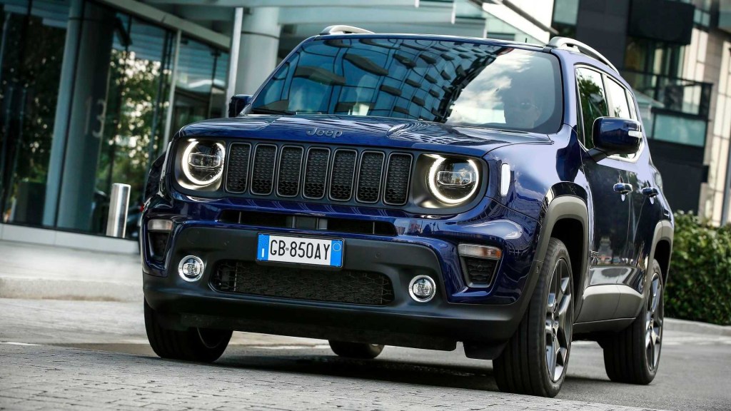 The 2021 Jeep Renegade 4xe driving down the street 