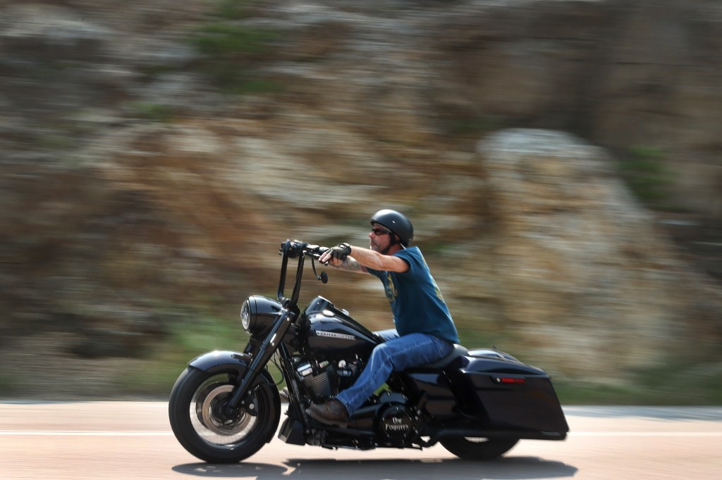 A man rides a motorcycle on the road to Mt. Rushmore on August 9, 2021, near Keystone, South Dakota. Motorcycle equipment rules dictate handlebar position, among other things.
