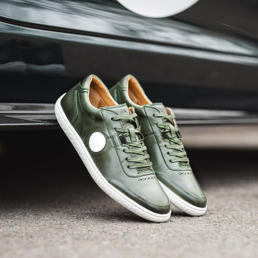 A pair of dark green and white Piloti driving shoes