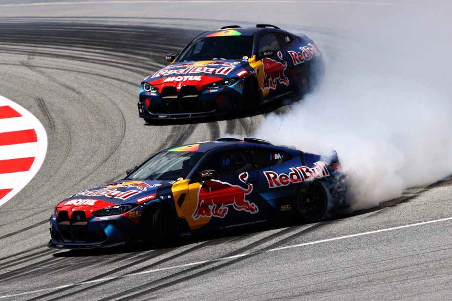 Two Red Bull drift cars drifting around a track