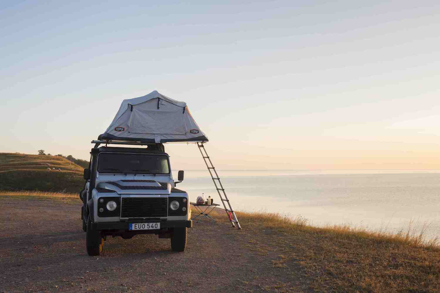 rooftop tent pitched next to cliff