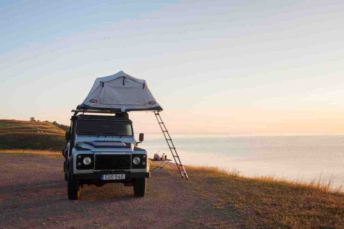 Overlanding rooftop tent pitched next to a cliff