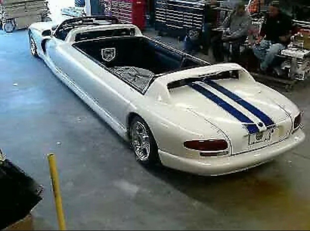 A white 1996 Dodge Viper limousine in a garage.