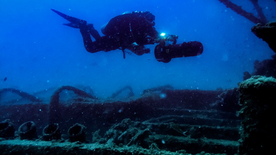 A scuba diver uses a sea scooter, also known as a diver propulsion vehicle (DPV), at a shipwreck in August 2017 outside Bonassola Liguria, Italy