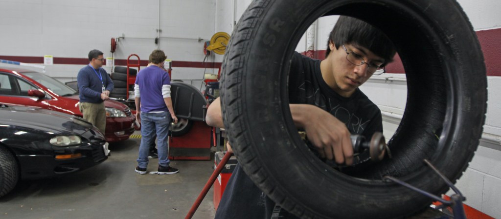 Student Joseph Ziemek patched a leaking tire during an auto tech class.