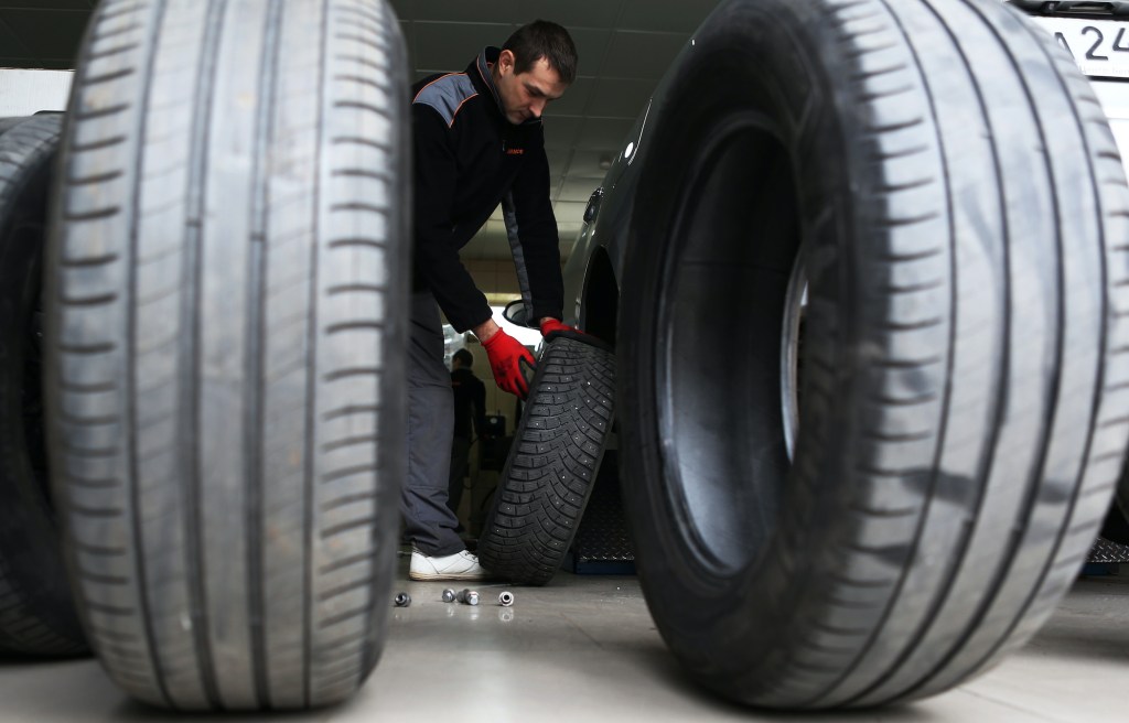 A car service worker fitting winter tires